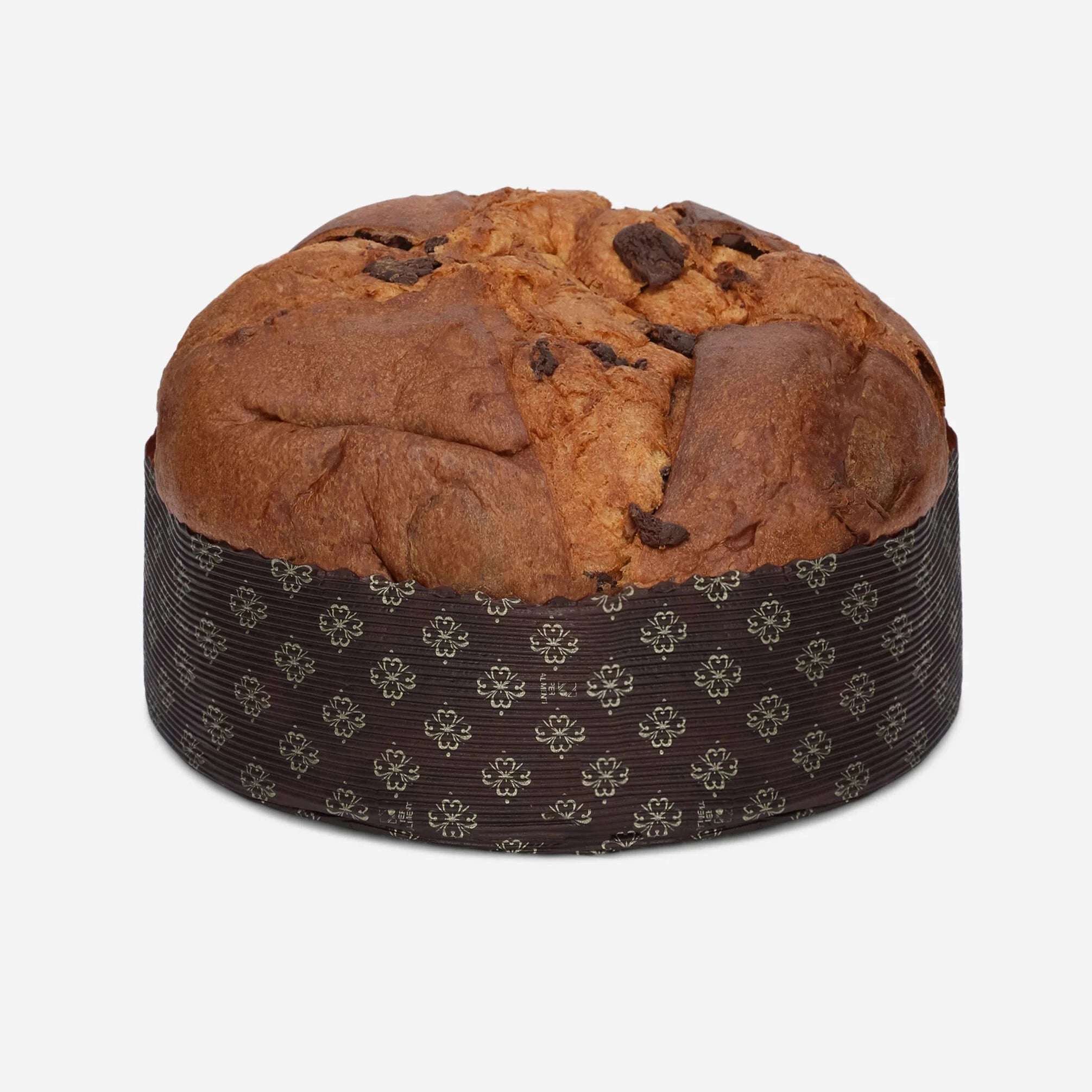 Round brown baked good with chocolate chips on a patterned container against a white background