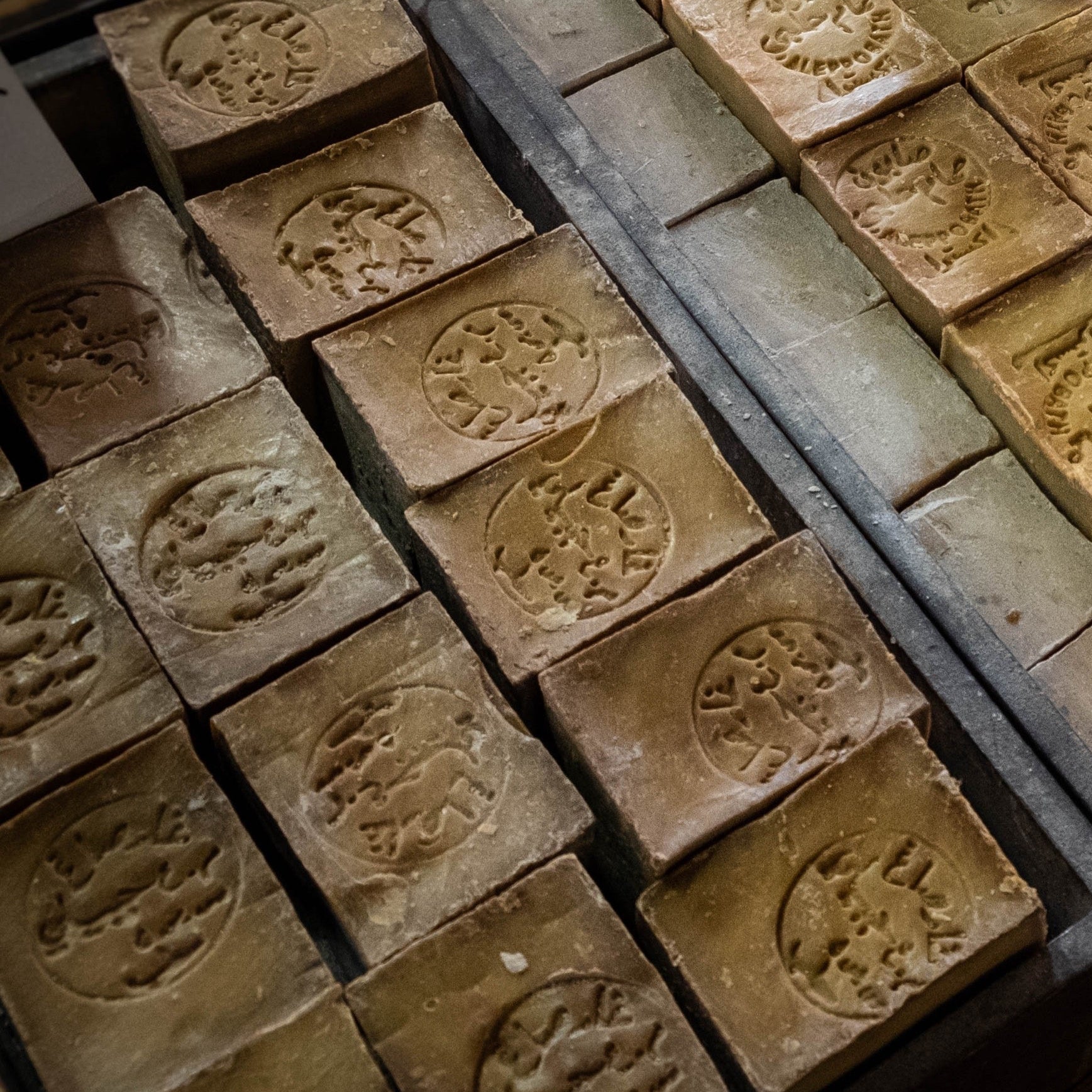 Collection of stone stamps with engraved patterns on a wooden surface